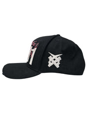 A right sided view of a black snapback baseball cap with hints of distressed texture and with embroidered pink floral blossom patterns between the 11.11 logo on a white backdrop. The right side of the cap has a white embroided 11.11 symbol logo on it
