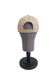 A back view of a beige snapback baseball cap on a mannequin head with a adjustable cap strap