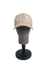 A front view of a beige snapback baseball cap on a mannequin head with an embroidered white 11.11 number logo