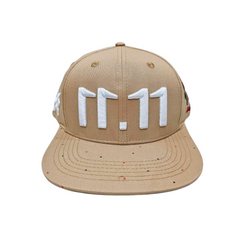 A front view of a beige snapback baseball cap with an embroidered white 11.11 number logo on a white backdrop.