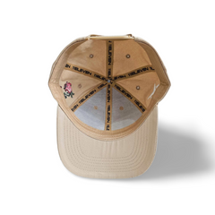 An inside view of a beige snapback baseball cap with seams printed with the 11ELEVEN logo on a white backdrop.