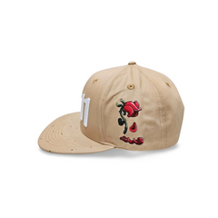 A right sided view of a beige snapback baseball cap with an embroidered white 11.11 number logo, also revealing The Broken Roses Illustration on the right side of the cap on a white backdrop.