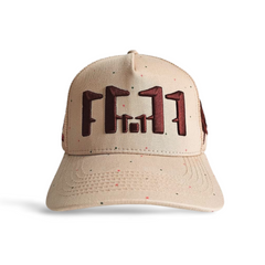 A front view of a beige snapback trucker cap with an embroidered brown 11.11 number logo on a white backdrop.