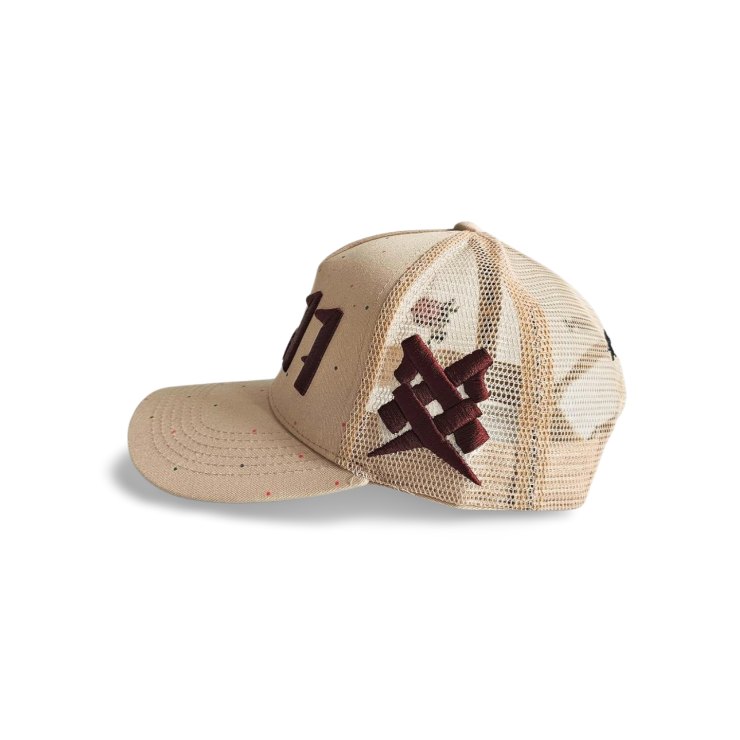 A right sided view of a beige snapback trucker cap with an embroidered brown 11.11 number logo. The right side of the cap reveals a brown embroidered 11ELEVEN symbol logo on the trucker mesh cap on a white backdrop.
