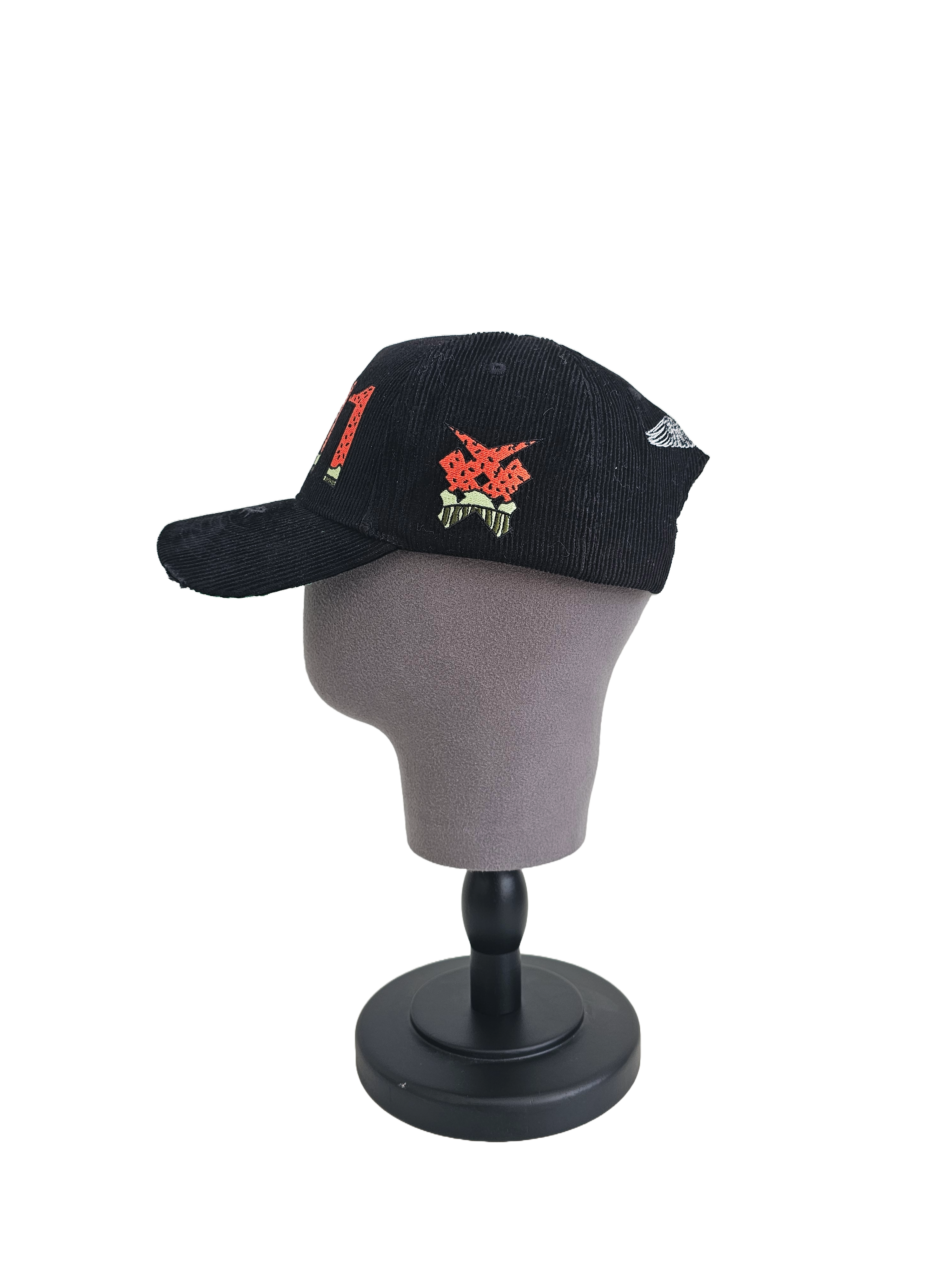 Side view of black corduroy Palestine snapback hat with 11:11 logo and embroidered watermelon slice. pro-Palestine streetwear with distressed brim and symbolic design.