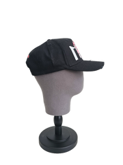 A left sided view of a black snapback baseball cap on a mannequin head with hints of distressed texture and with embroidered pink floral blossom patterns between the 11.11 logo on a white backdrop.